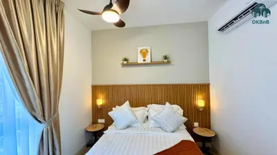 a bedroom with a bed with a wooden headboard at Neu Suites by OKBnB in Kuala Lumpur
