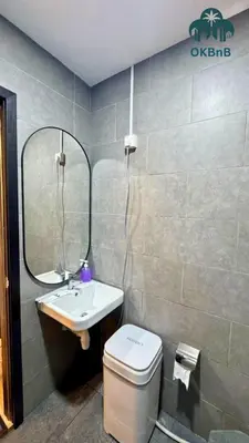 a bathroom with a sink and a toilet and a mirror at Neu Suites by OKBnB in Kuala Lumpur