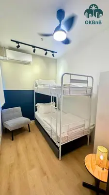 a room with two bunk beds and a ceiling fan at Neu Suites by OKBnB in Kuala Lumpur