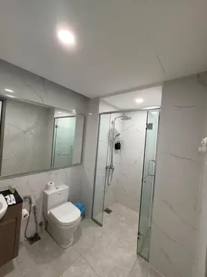 a bathroom with a toilet and a glass shower at Agile Bukit Bintang Suits TRX Pavilion By Klcc Sky view 60 floor in Kuala Lumpur