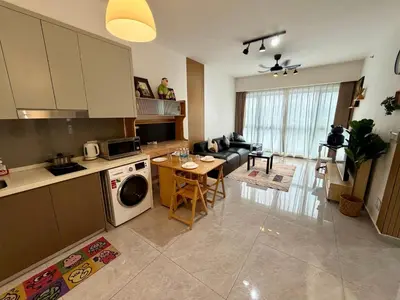 a kitchen and living room with a couch and a table at Agile Bukit Bintang Suits TRX Pavilion By Klcc Sky view 60 floor in Kuala Lumpur