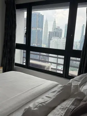 a bedroom with a view of a city from a window at Agile Bukit Bintang Suits TRX Pavilion By Klcc Sky view 60 floor in Kuala Lumpur