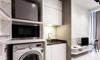 a kitchen with a washing machine and a sink at Expressions Suite by Rudiman in Kuala Lumpur