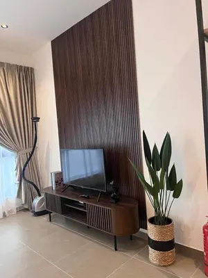 a living room with a flat screen tv and a plant at Expressions Suite by Rudiman in Kuala Lumpur
