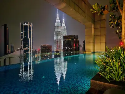 a swimming pool on top of a building with a city skyline at DD Royce Residence KLCC in Kuala Lumpur