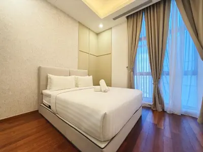 a white bed in a room with a large window at DD Royce Residence KLCC in Kuala Lumpur