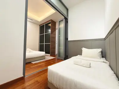 a bedroom with two beds and a large mirror at DD Royce Residence KLCC in Kuala Lumpur