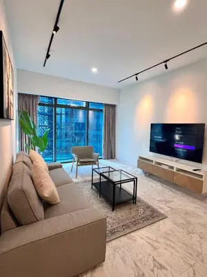 a living room with a couch and a tv at \u4f0a\u987f\u9152\u5e97\u516c\u5bd3 in Kuala Lumpur