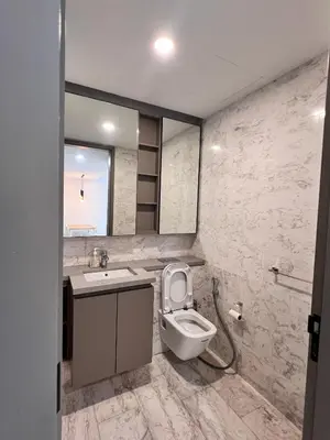 a bathroom with a toilet and a sink and a mirror at \u4f0a\u987f\u9152\u5e97\u516c\u5bd3 in Kuala Lumpur