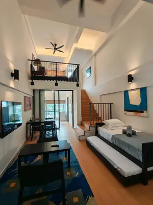 a bedroom with a bed and a ceiling fan at Urban Designer's Duplex in Ampang