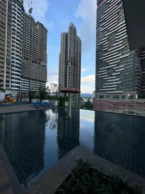 a swimming pool in a city with tall buildings at KLCC View Suites By Reizz Residence in Kuala Lumpur