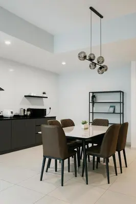 a dining room with a table and chairs at KLCC View Suites By Reizz Residence in Kuala Lumpur
