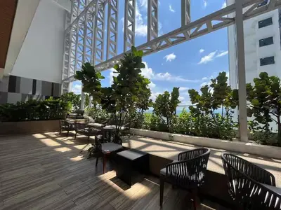 a balcony with tables and chairs on a building at The Colony By Infinitum Q in Kuala Lumpur