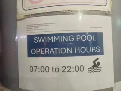 a sign that says swimming pool operation hours at The Colony By Infinitum Q in Kuala Lumpur