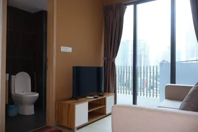a living room with a tv and a toilet at The Colony By Infinitum B in Kuala Lumpur