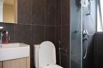 a bathroom with a shower and a toilet and a sink at The Colony By Infinitum B in Kuala Lumpur