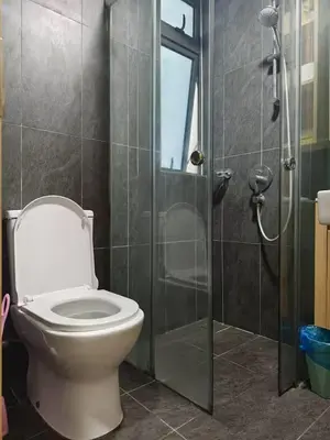 a bathroom with a toilet and a glass shower at The Colony By Infinitum G in Kuala Lumpur
