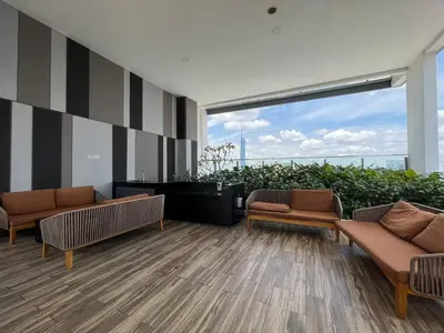 a lobby with two couches and a large window at The Colony By Infinitum T in Kuala Lumpur
