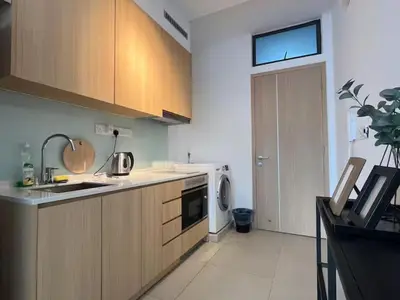 a kitchen with a sink and a washer and dryer at The Colony By Infinitum N in Kuala Lumpur
