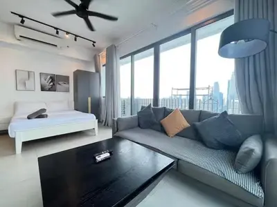 a living room with a couch and a bed at The Colony By Infinitum N in Kuala Lumpur