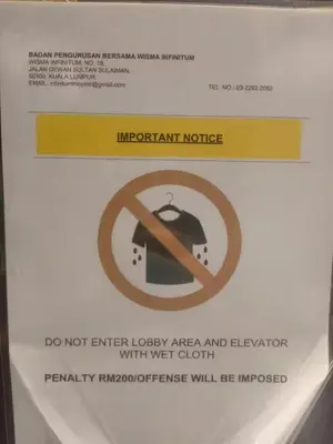 a sign on the side of a bathroom stall at The Colony By Infinitum K in Kuala Lumpur