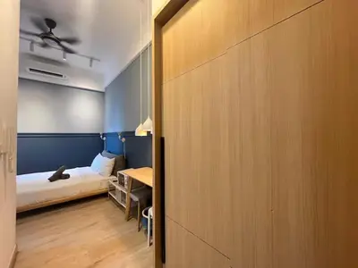 a bedroom with a bed and a table in a room at The Colony By Infinitum K in Kuala Lumpur