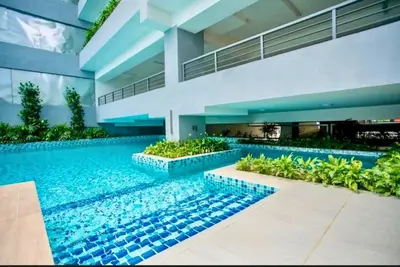 a house with a swimming pool in front of it at Comfy 2BR with FREE Parking at Neu Suites by OKBnB in Kuala Lumpur
