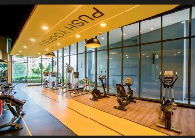 a gym with a row of treadmills and elliptical machines at Comfy 2BR with FREE Parking at Neu Suites by OKBnB in Kuala Lumpur