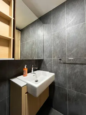 a bathroom with a white sink and a shower at The Colony By Infinitum E in Kuala Lumpur