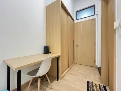 a small room with a desk and a closet at The Colony By Infinitum H in Kuala Lumpur