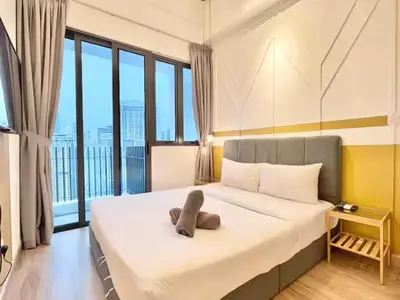 a bedroom with a teddy bear laying on a bed at The Colony By Infinitum A in Kuala Lumpur