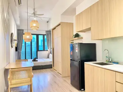 a kitchen with a black refrigerator and a dining room at The Colony By Infinitum A in Kuala Lumpur