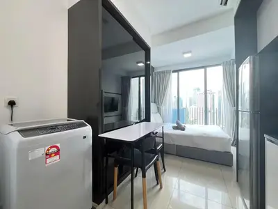 a small kitchen with a refrigerator and a bedroom at The Colony By Infinitum M in Kuala Lumpur