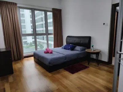 a bed in a room with a large window at Regalia Suites in Kuala Lumpur