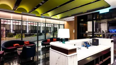 a lobby with chairs and a reception desk in a building at Imperial Residence Kuala Lumpur in Kuala Lumpur