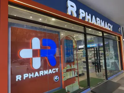 a pharmacy sign in the window of a store at Trion Skyview Residence KL City Centre in Kuala Lumpur