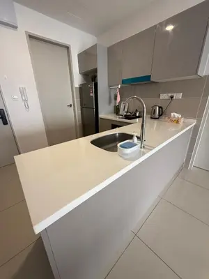 a white kitchen with a sink and a refrigerator at Trion Skyview Residence KL City Centre in Kuala Lumpur