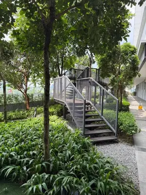 a metal staircase in a park with plants at Trion Skyview Residence KL City Centre in Kuala Lumpur