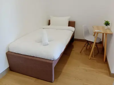 a bed in a room with a table and a chair at Lucentia Residence by Infinity swimming pool,lalaport KL in Kuala Lumpur