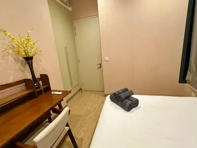 a room with a table and a bed and a vase at Lucentia Residence by Infinity swimming pool,lalaport KL in Kuala Lumpur