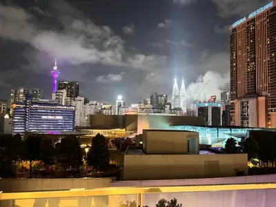 a view of a city skyline at night at Lucentia Residence by Infinity swimming pool,lalaport KL in Kuala Lumpur