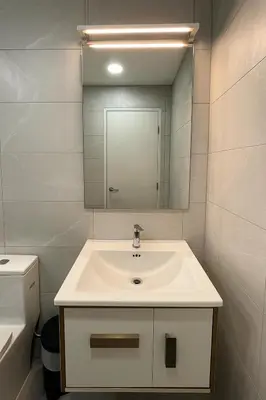 a white bathroom with a sink and a mirror at Majestic Residence by Aranova Stay in Kuala Lumpur