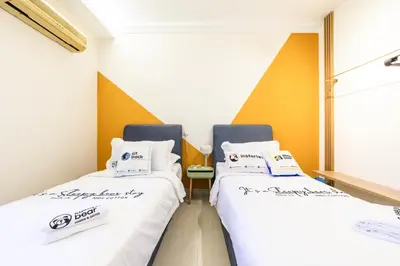 two beds in a hospital room with white sheets at Royal Domain KL near Mont Kiara by Sleepy Bear in Kuala Lumpur