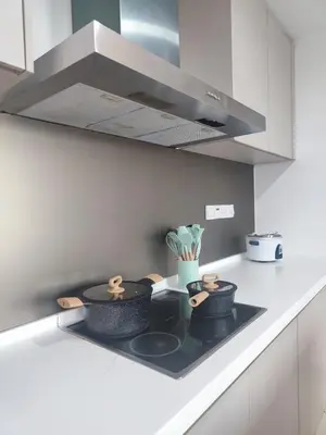 a stove top with pots and pans on it in a kitchen at Suasana Bukit Ceylon with Panda Themes KL Tower View in Kuala Lumpur