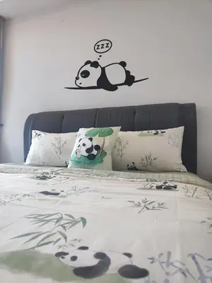 a bed with a panda bear sticker on the wall at Suasana Bukit Ceylon with Panda Themes KL Tower View in Kuala Lumpur
