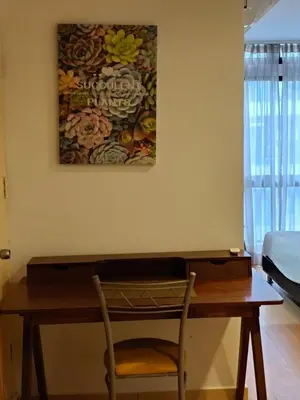 a desk in a room with a painting on the wall at Fahrenheit 88 Pavilion TRX 2 BedRoom 2 Bathroom Bukit Bintang in Kuala Lumpur