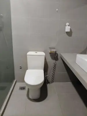 a bathroom with a white toilet and a sink at Fahrenheit 88 Pavilion TRX 2 BedRoom 2 Bathroom Bukit Bintang in Kuala Lumpur