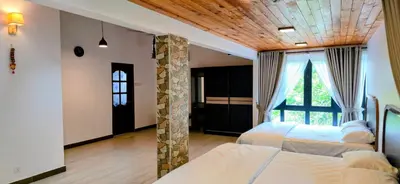 a bedroom with two beds and a large window at Gasing WheelHouse in Petaling Jaya