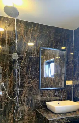 a bathroom with a shower and a sink and a mirror at Gasing WheelHouse in Petaling Jaya
