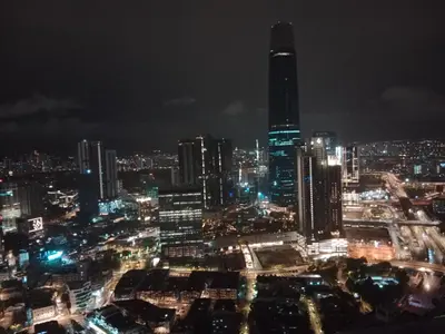 a city skyline at night with a tall building at Afrin Service Suits at Berjaya Times Square in Kuala Lumpur